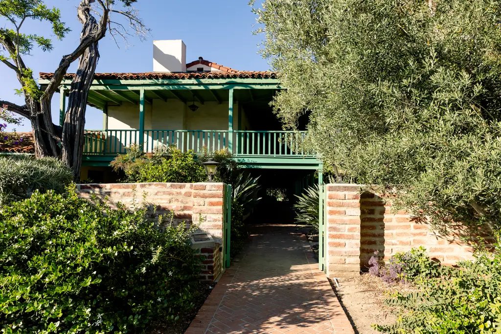 Green porch on a two-story house.