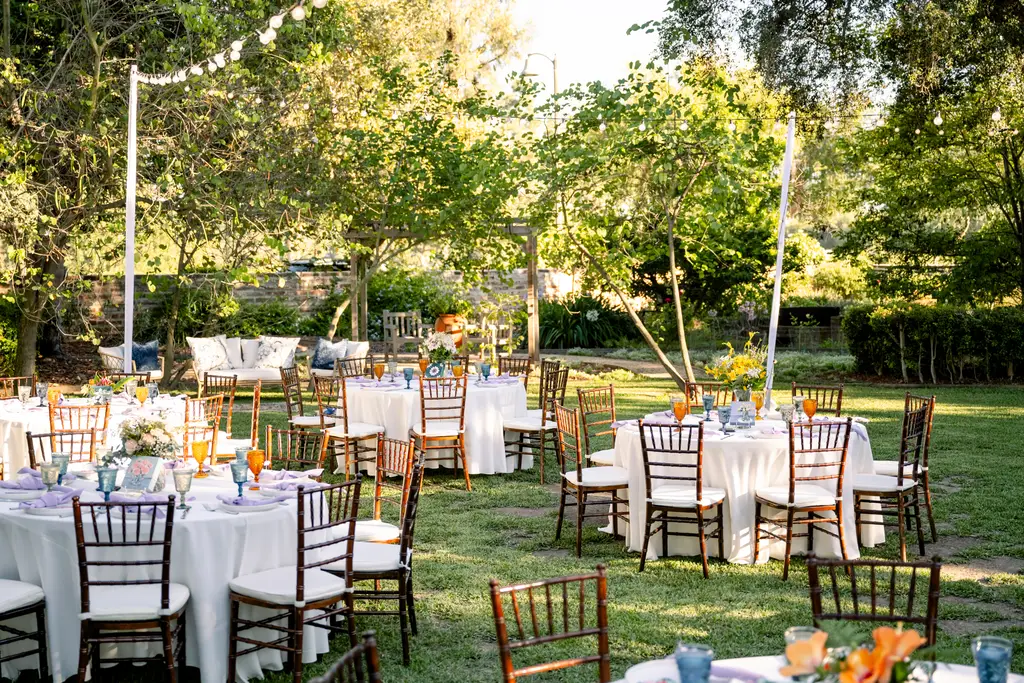 Outdoor wedding reception in garden setting.