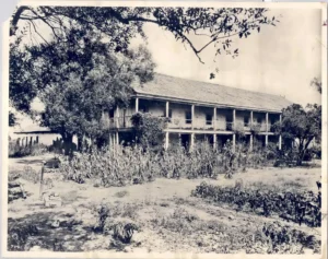 Historic two-story adobe building with front balcony