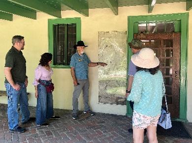 Group touring and observing historical building.