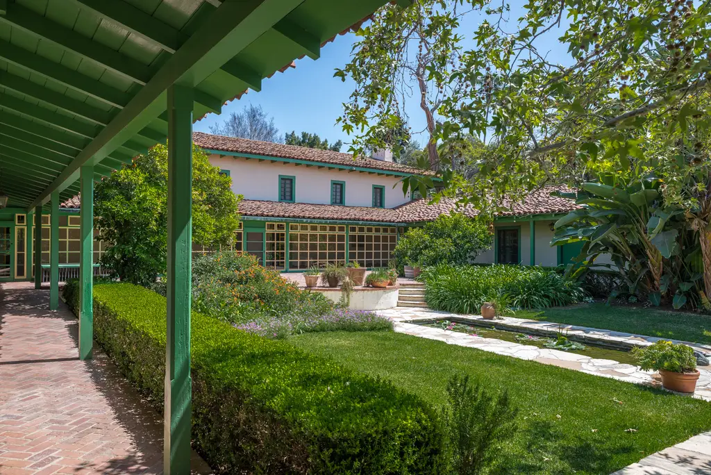 Mediterranean-style house with lush garden and walkway.