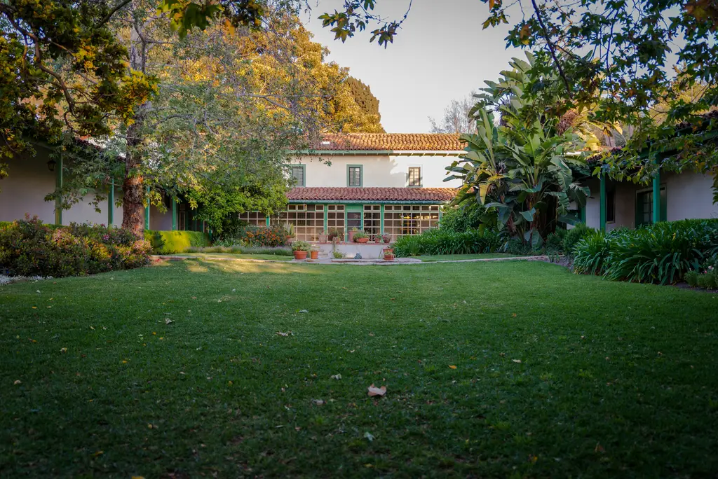 Large backyard garden and rustic house view