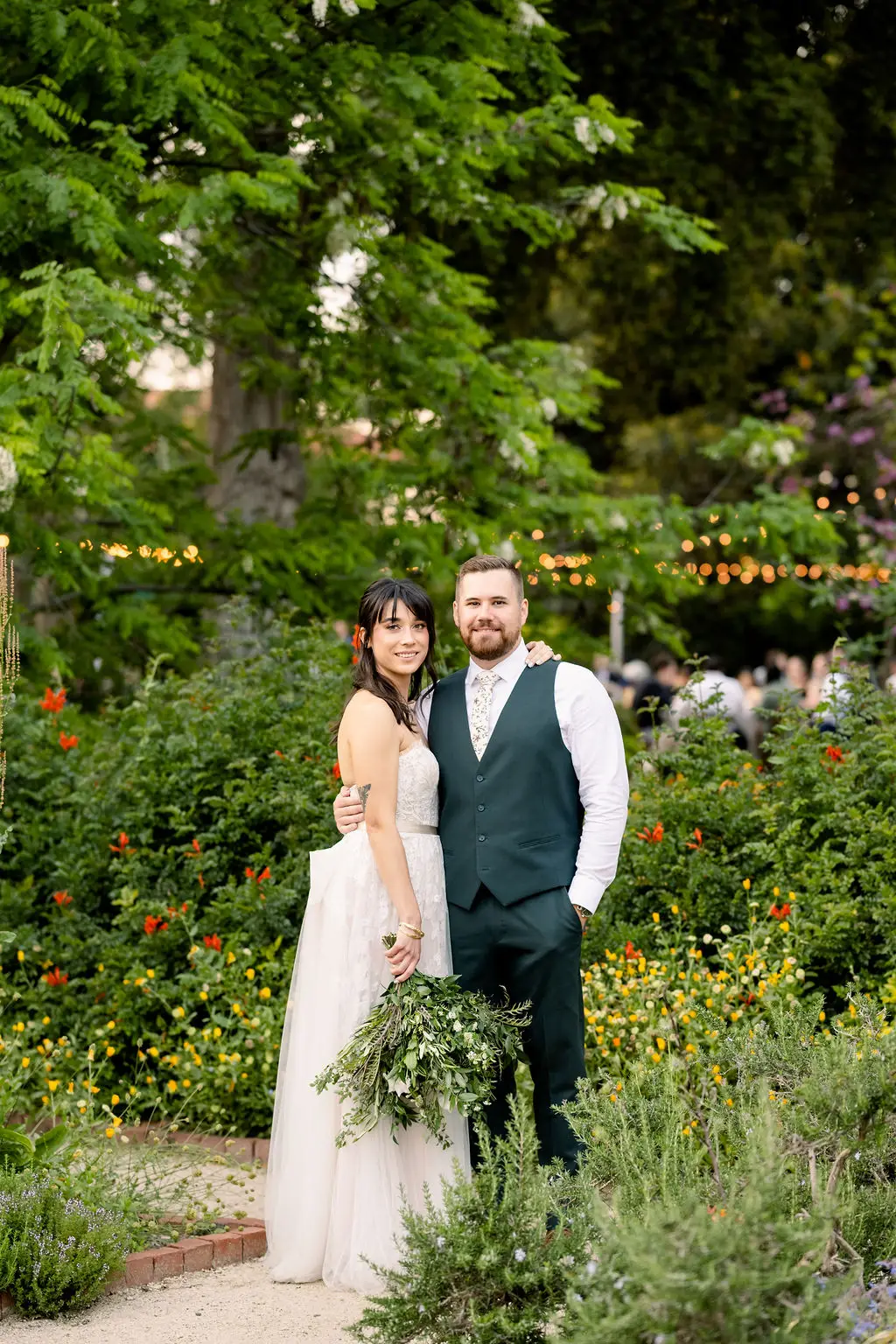 Couple posing in lush garden during wedding