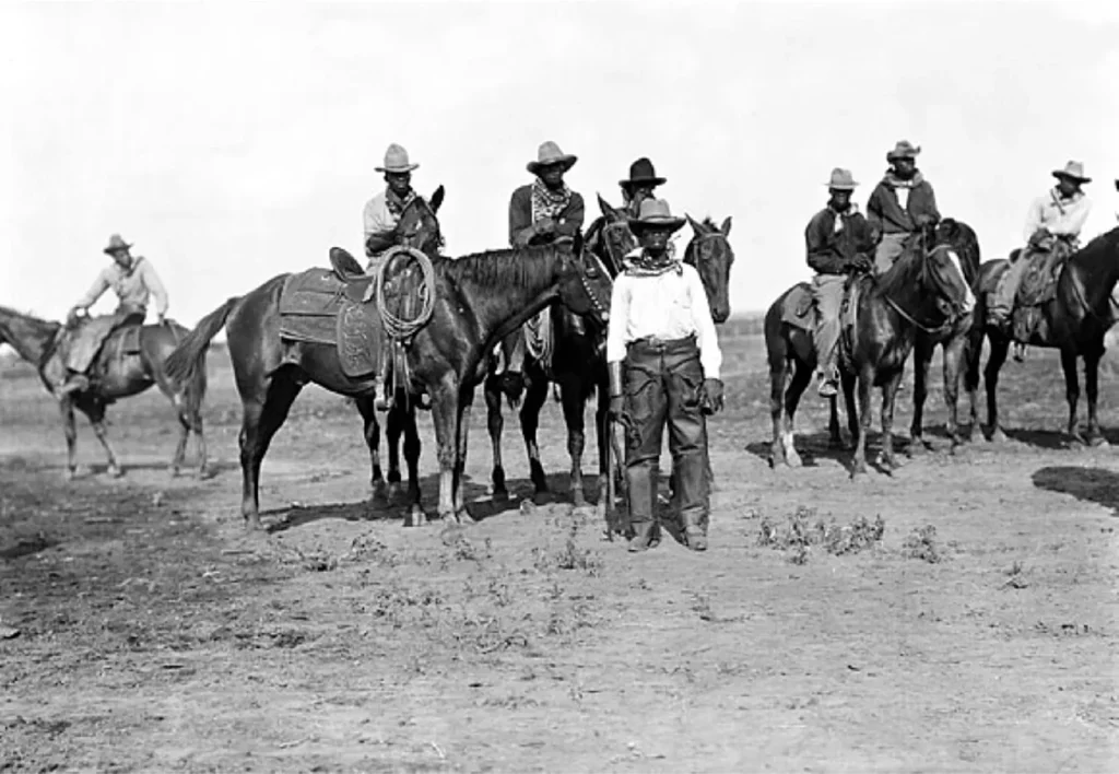 Historic Black cowboys on horseback, Texas prairie scene.