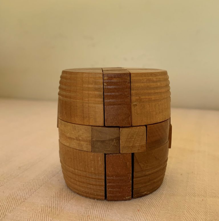 Wooden barrel puzzle on beige surface