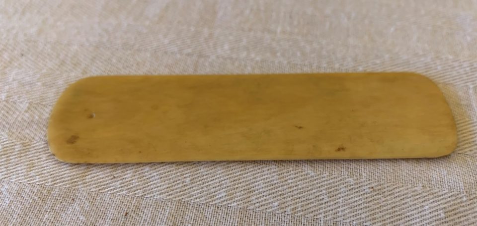 Vintage horn shoehorn on textured fabric