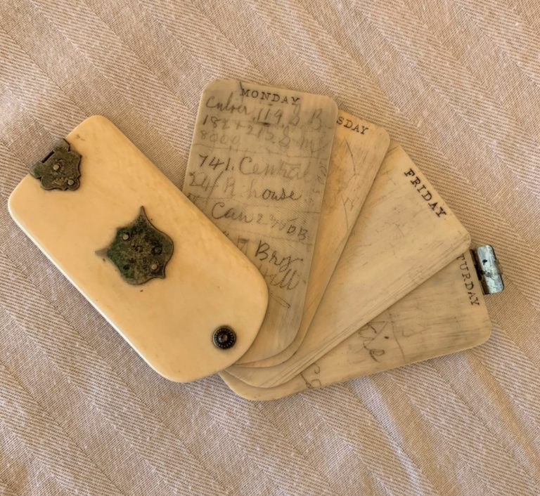 Vintage reusable calendar with handwritten notes.