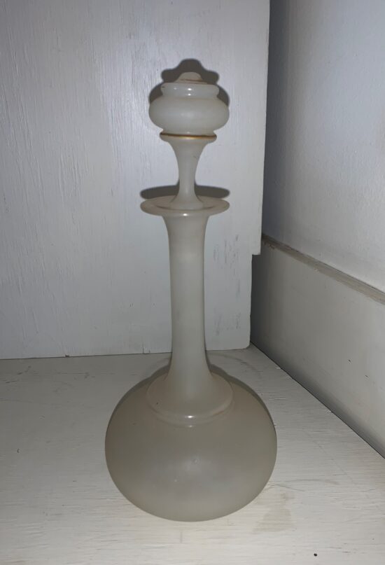 Vintage glass bottle on wooden surface