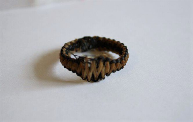 Handmade braided hemp ring on white background