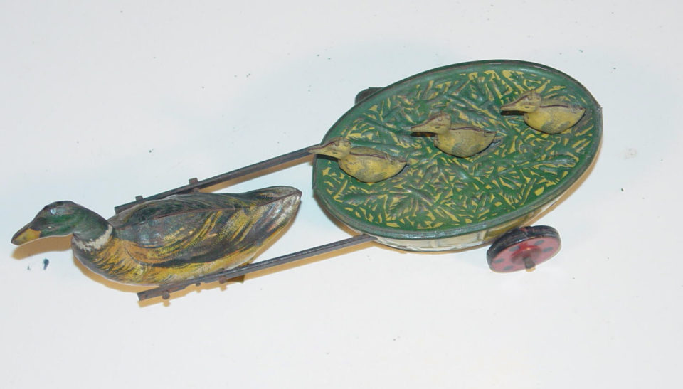 Vintage tin duck pull toy with wheels