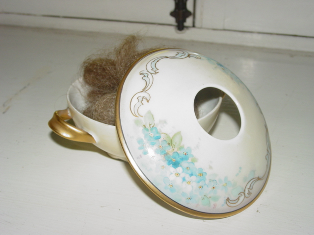 Antique hair receiver with floral design.
