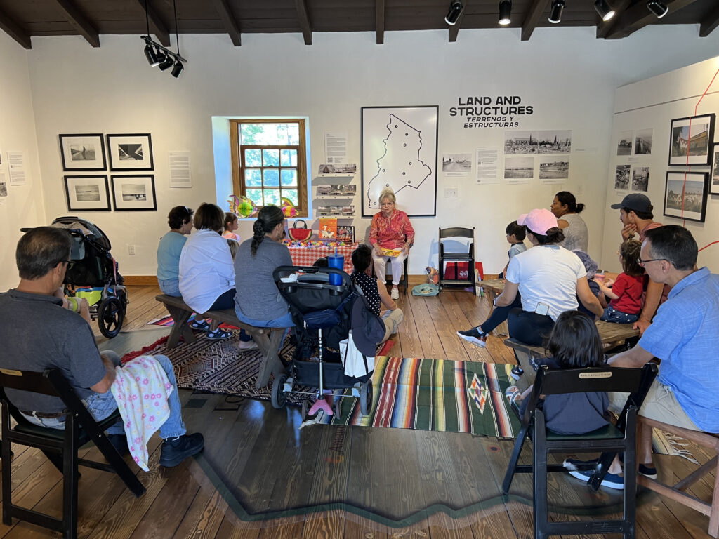 Storytime event in gallery with group of people.