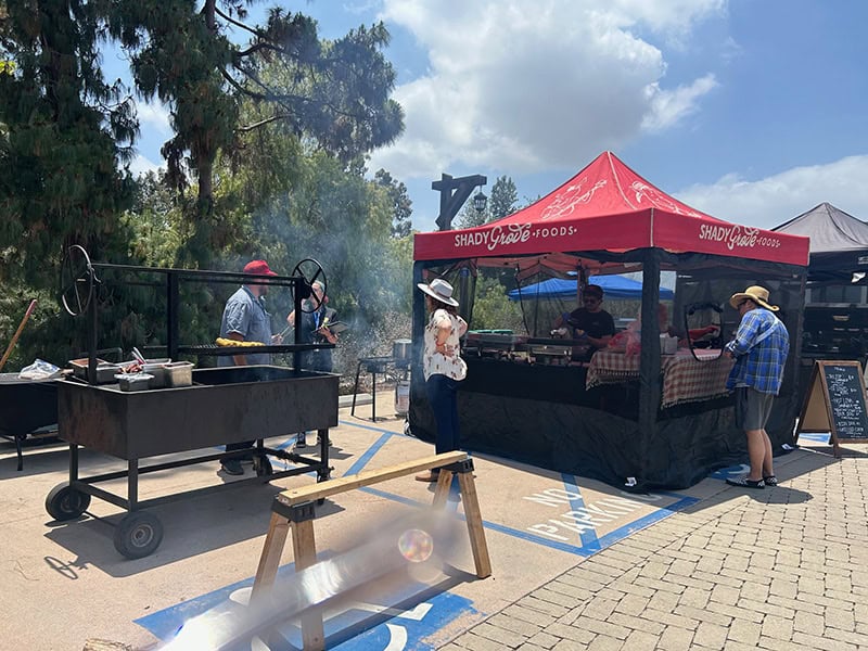 Outdoor BBQ event with Shady Grove Foods tent.